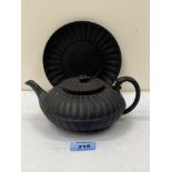 An early 19th century Wedgwood black basalt teapot and stand, of compressed globular form with metal