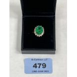 A 9ct green stone and diamond cluster ring. 3g gross. Size M