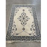 A cream ground kashan rug