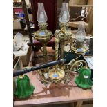 A two light brass hanging lamp and three brass oil lamps converted to electric light