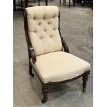 A Victorian mahogany and upholstered nursing chair with buttoned back
