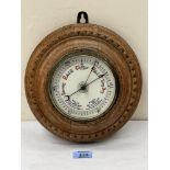 A Victorian oak framed aneroid wall barometer. 9' diam
