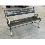 A cast iron and wood slatted garden bench. 47' wide