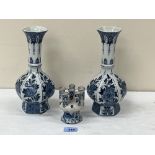 A 19th century Dutch Delft tulip vase, 3¾' high and a pair of late Delft blue and white baluster