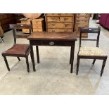 A George III mahogany tea table and two Regency mahogany dining chairs