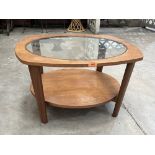 A 1970s glass topped two tier coffee table