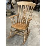 A beechwood rocking chair, the lath back with shaped pierced splat.