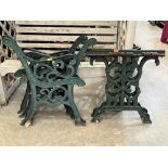 Two pairs of cast iron bench ends and a pair of cast iron table ends
