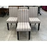 A set of four modern upholstered dining chairs