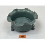 A Chinese celadon crackle glazed bowl with crimped rim, the centre with a beast in low relief,