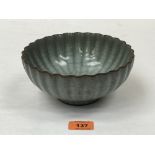 A Chinese celadon crackle glazed fluted bowl. 7¼' diam.