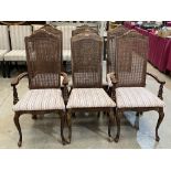 A set of six dining chairs with caned backs