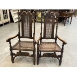 A pair of walnut Carolean style armchairs with caned seats and backs