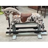 An early 20th century painted wood rocking horse on trestle stand. 36' long.