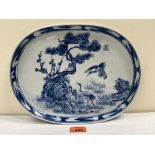 An oriental blue and white oval dish decorated with cranes in a landscape. 12' wide