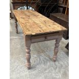 A Victorian and later pine farmhouse table, the scrubbed pine plank top over a frieze drawer on