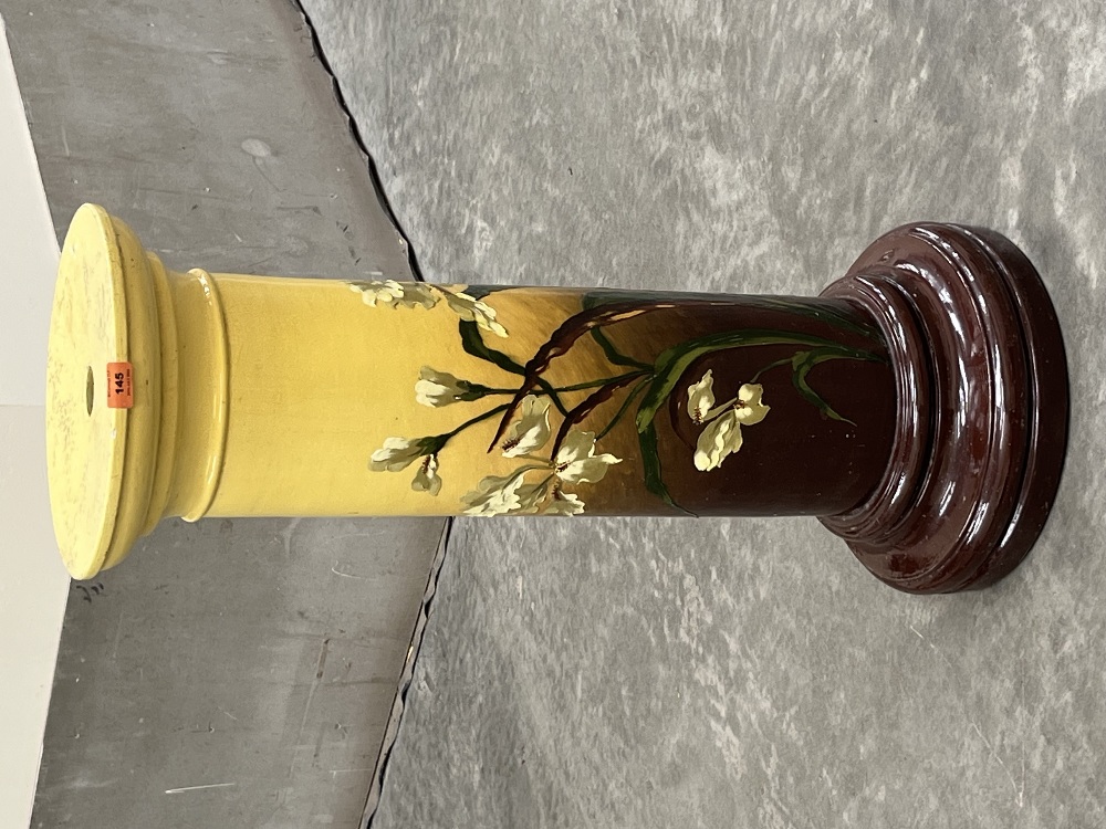 A Victorian Burmantofts Faience jardiniere pedestal, painted with iris flowers on a yellow and brown