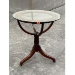 A mahogany terrestrial or celestial globe frame on tripod support, fitted with glass top. 27' diam