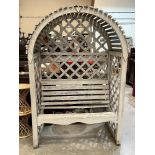 A garden seat in a trellised and slatted arch. 52'w x 77'h. Losses to seat slats