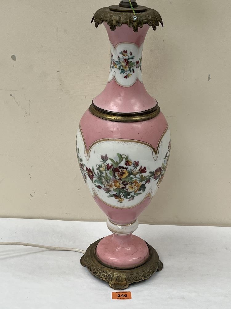 A 19th century continental table lamp, decorated with a continuous band of summer flowers on a