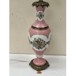 A 19th century continental table lamp, decorated with a continuous band of summer flowers on a