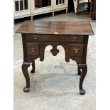 An oak lowboy with three drawers to the shaped apron, on cabriole legs. 31" wide