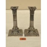 A pair of Victorian Adam revival columnar candlesticks, the downswept square bases with ribbon-tie