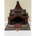 A wooden model of an Asian Christian shrine. 20' high. (A.F.)