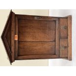 An oak wall cupboard, enclosed by a panel door over a pair of drawers. 24' high