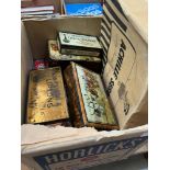 Two boxes of vintage tins, cigarette packets and a dispenser