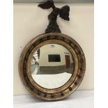 A Regency convex looking glass with associated carved wood eagle surmount. 19' diam x 27' high