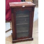 A Victorian mahogany music cabinet enclosed by a glazed door. 35½' high