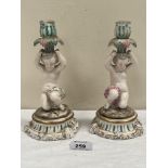 A pair of Sitzendorf figural candlesticks. 8½' high