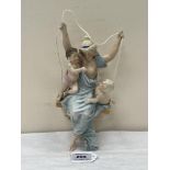 A German porcelain girl on a swing group. 9¾' high