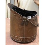An Arts and Crafts copper coal bucket. 15' high