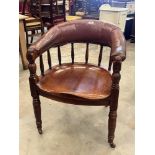 A Victorian smoker's bow armchair with leather upholstered back and arms