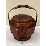 An oriental octagonal decorated wood carrying vessel and cover. 10' diam