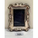 An Edward VII silver photograph frame. Birmingham 1907. 5¼' high. Strut lacking