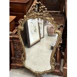 A gilt metal framed wall mirror. 36' high