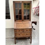 Heal and Son; London. An oak bureau bookcase on moulded square legs. 29' wide