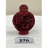 A Chinese carved cinnabar snuff bottle. 2½' high