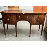 A George IV bow-breakfronted mahogany and line inlaid sideboard, the centre drawer flanked by a pair