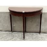 A mahogany and satinwood banded demi-lune card table on square tapered legs with spade terminals and