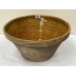 An earthenware dough bowl, the interior glazed. 17' diam.