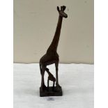 An African carved wood giraffe and calf group