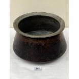 An African hammered copper cooking vessel, the interior tinned. 11¼' diam