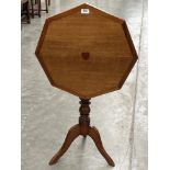 A Victorian oak snap-top table, the octagonal top inlaid with a heart motif. 22' diam.