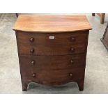 A 19th century mahogany commode in the form of a bowfronted chest of drawers. 26' wide
