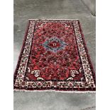 An Iranian red ground carpet. 84' x 59'