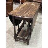 An oak drop drop leaf table on moulded turned legs and perimeter stretchers. 41' wide